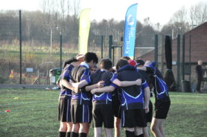 kids in a rugby huddle