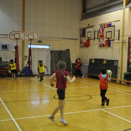 Children playing sports in the hall