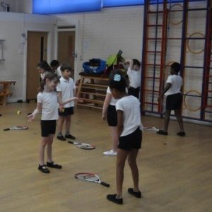 Children doing PE in sports hall