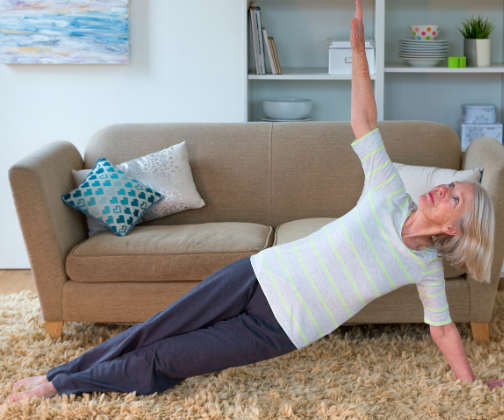 Woman exercising in front of a sofa