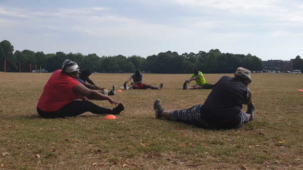 Ladies sitting down stretching