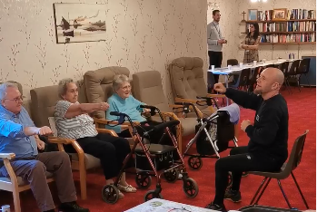Care home residents lifting weights