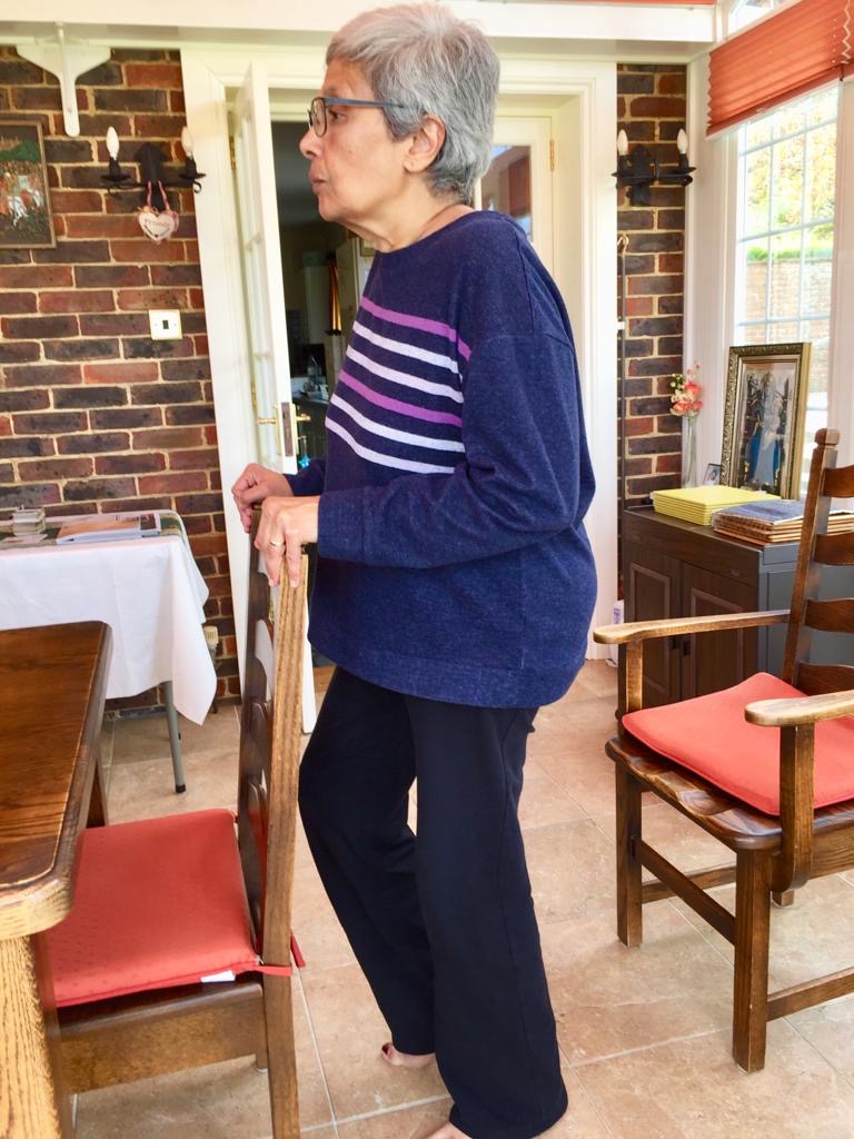 Lady using chair to support pilates