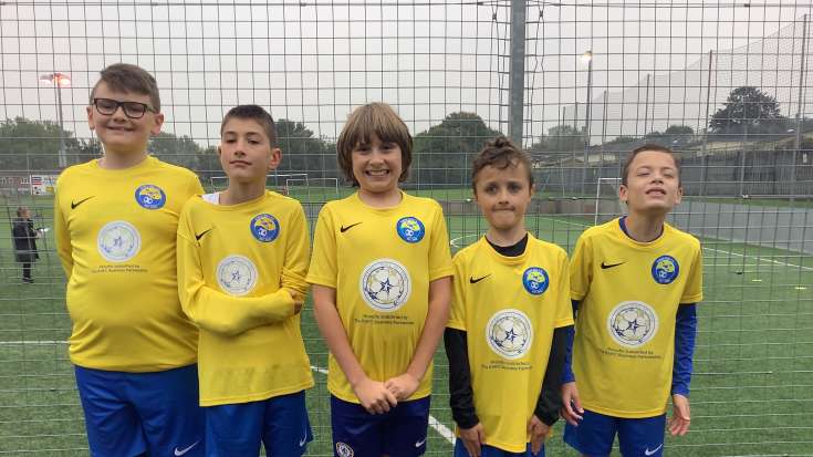 5 boys in football kit