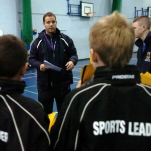 Coach talking to sports leaders