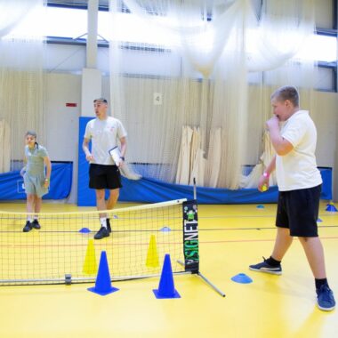 boys playing indoor tennis