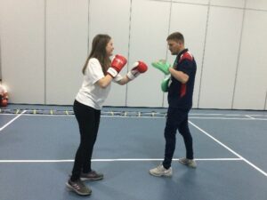 young girl boxing with a coach from olympia boxing