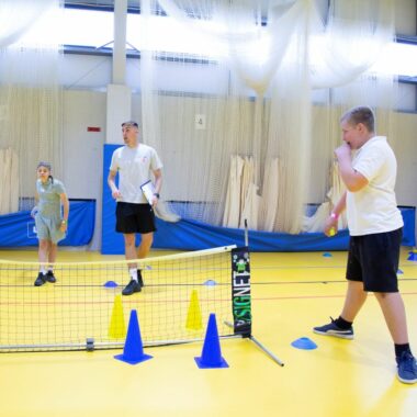 boys playing indoor tennis