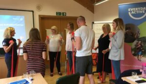 people using resistance bands at a workshop