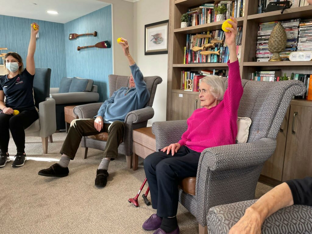 older people seated and stretching