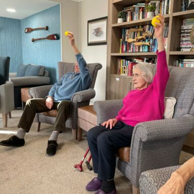 older people seated and stretching