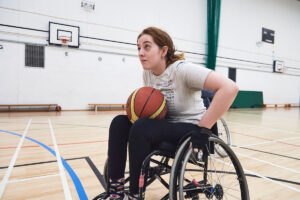 person in wheelchair playing basketball