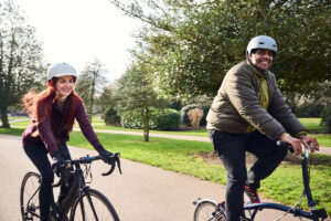 two people cycling in a park