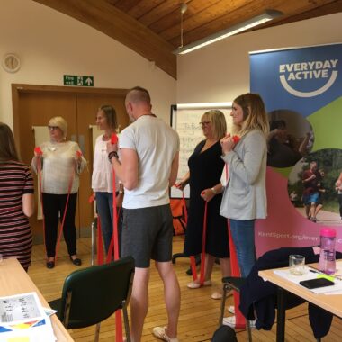 group of people at a workshop using resistance bands