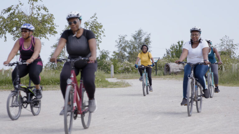 group of women cycling in a park