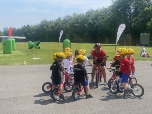 children on bikes listening to a teacher