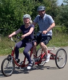 two people on an adapted bike