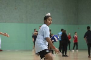 young person in sports hall playing dodgeball