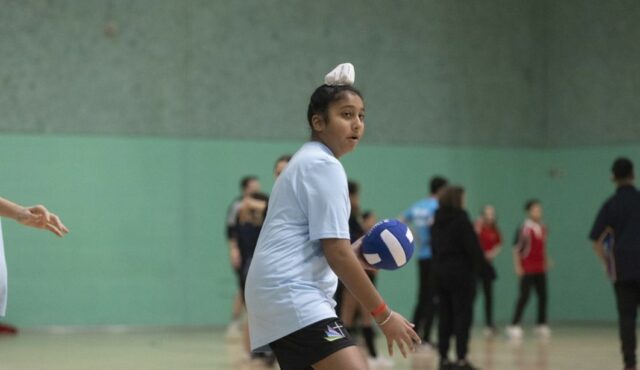 young person in sports hall playing dodgeball