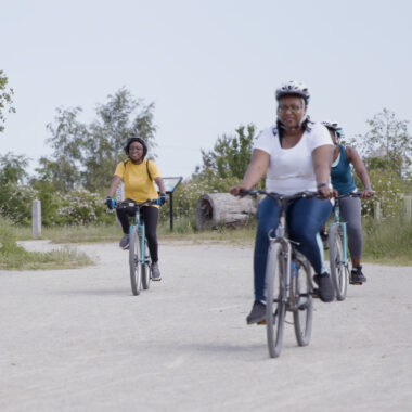 group of women cycling in a park