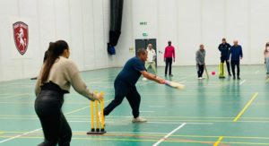 group of people playing walking cricket in sports hall