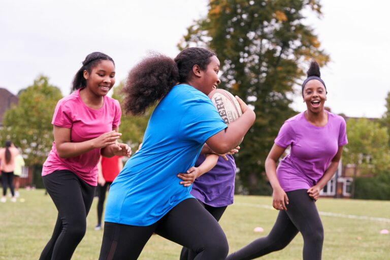 group of young girls playing rugby