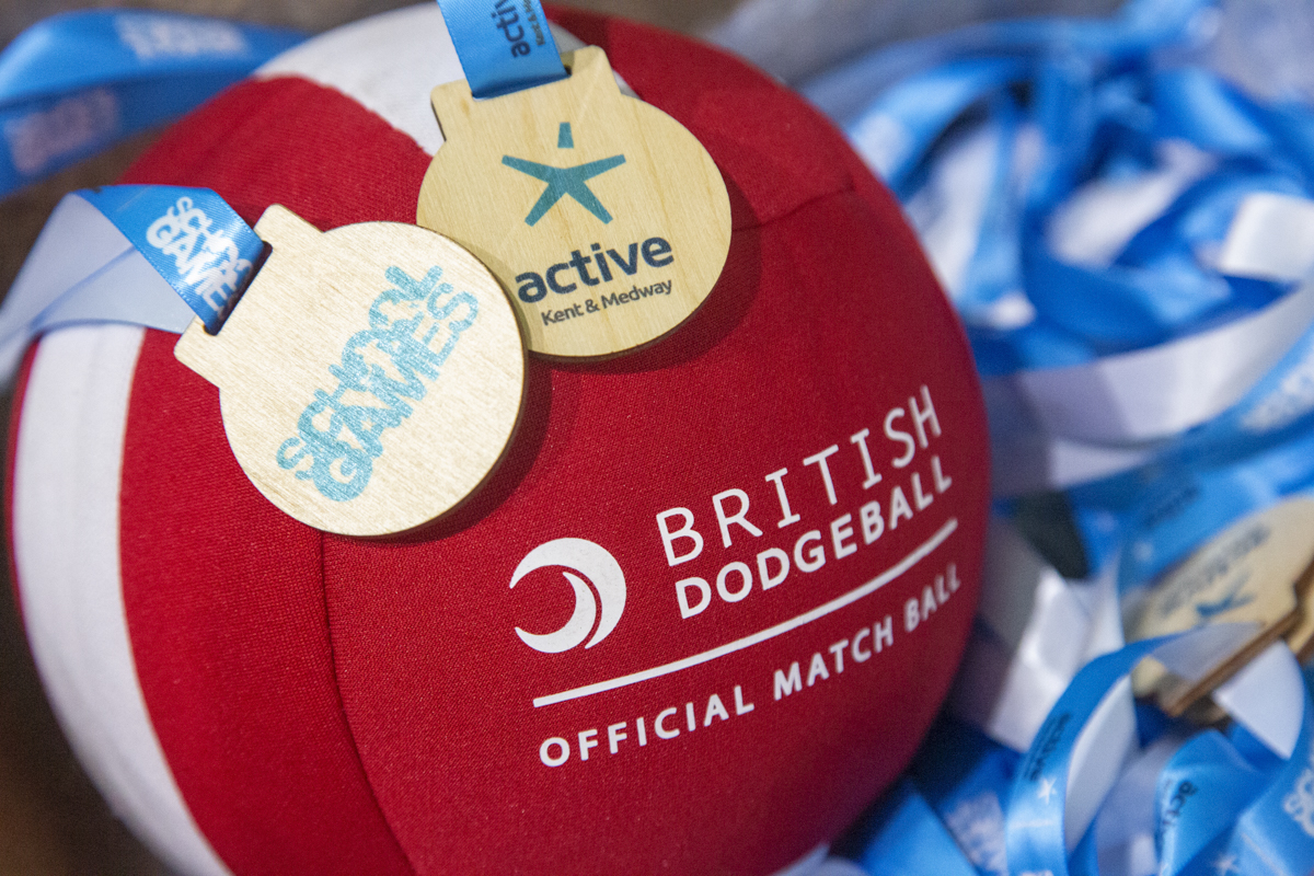 British Dodgeball ball with School Games and Active Kent and Medway medals laid over