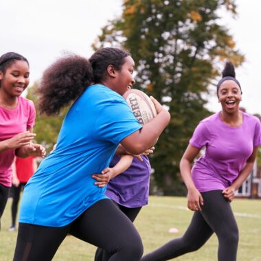 group of young girls playing rugby