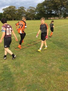 group of young people training on a field