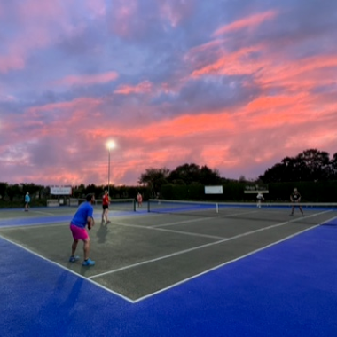 Tennis court with sunset behind