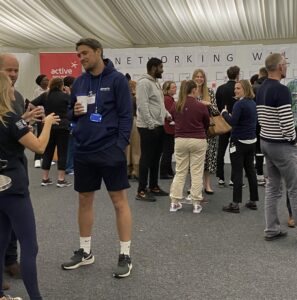 Group of people standing and talking at the networking wall