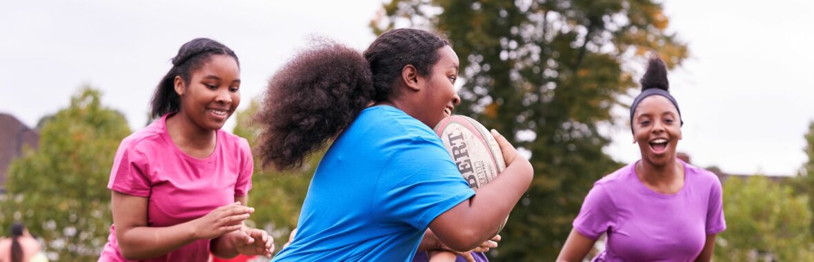 group of young girls playing rugby