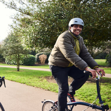 two people cycling in a park