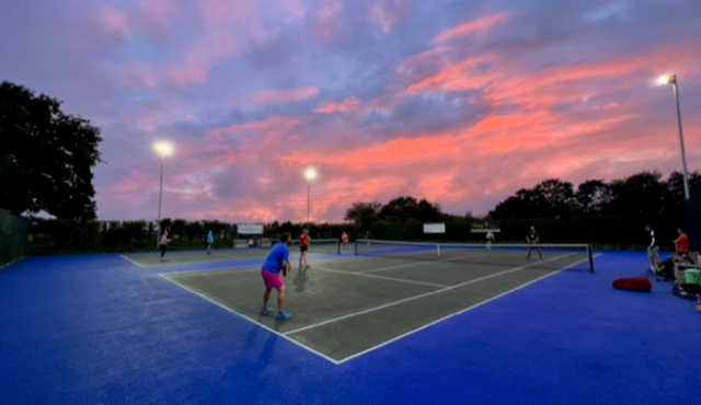 Tennis court with sunset behind