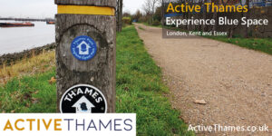 Image of footpath alongside body of water with Thames River Walk sign