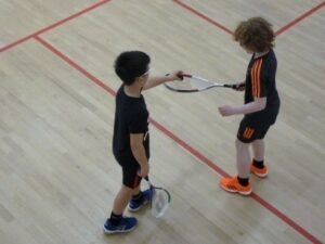 young boys playing squash