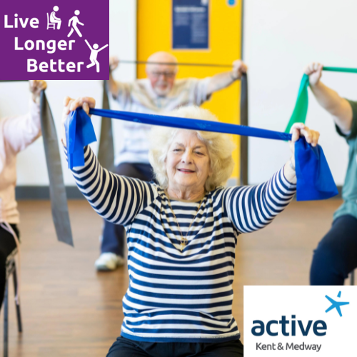 lady holding up a resistance band while sat in a chair