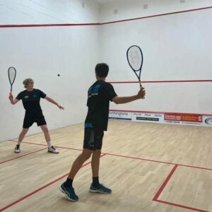 Teenage boys playing squash