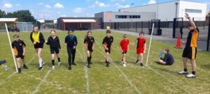 Group of children at the start of a running race on a school field