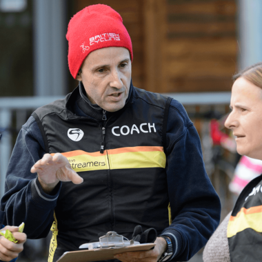 Coach chatting with two volunteers