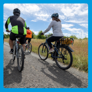 Group of people cycling along a wide path