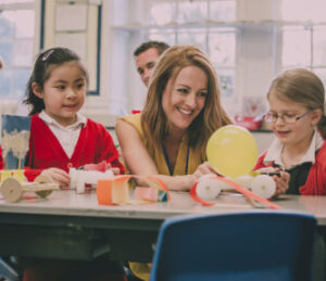 teacher with two children in a classroom