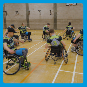 Group of people in wheelchairs in a sports hall