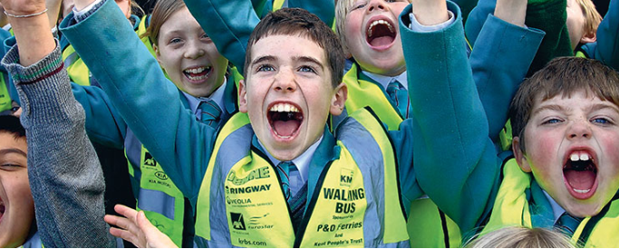 Children walking to school smiling