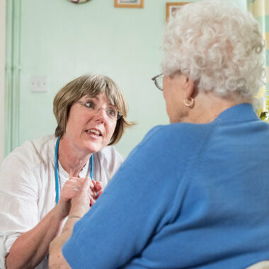 a health care profressional speaking to an older lady