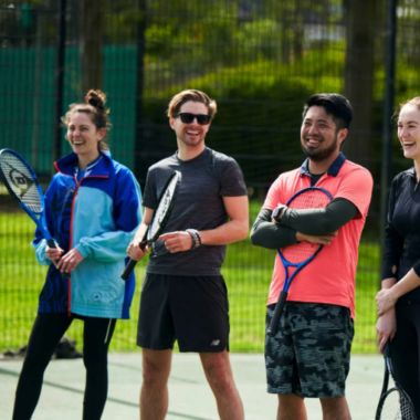 people standing on a tennis court