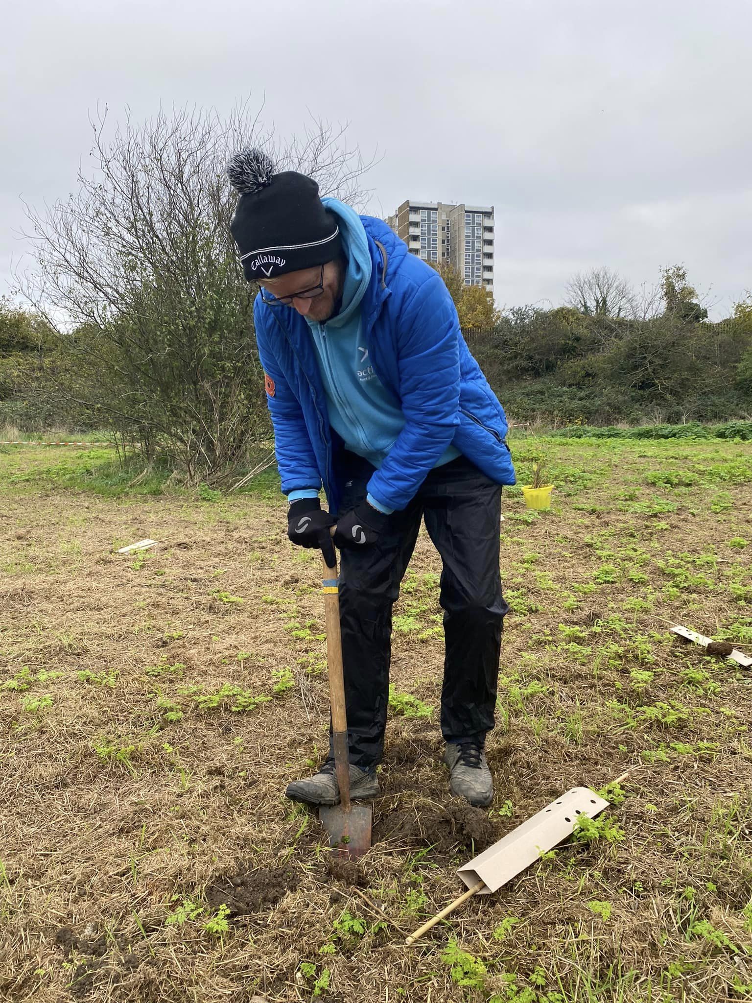 person digging a hole in the ground iwht a spade