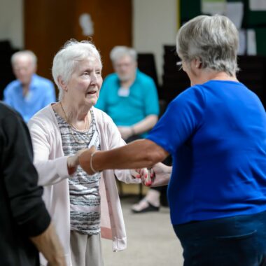 lady in an exercise class in a community hall