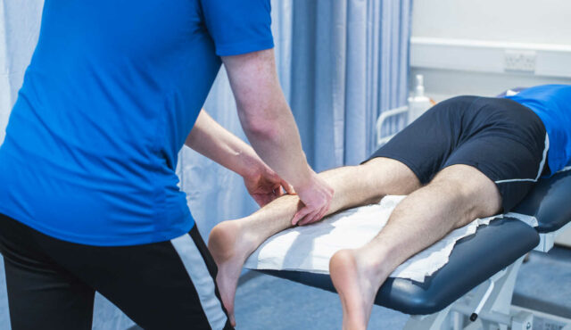 person lying on a table getting a leg massage