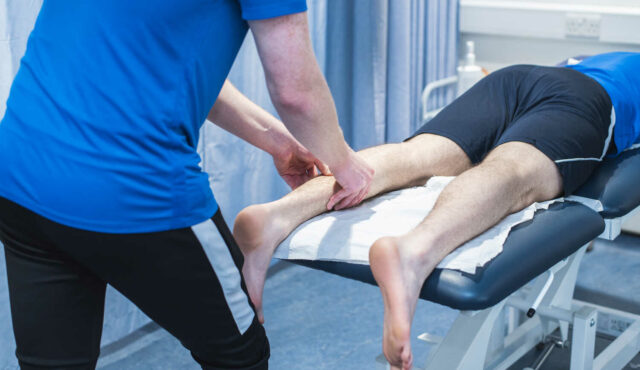 person lying on a table getting a leg massage